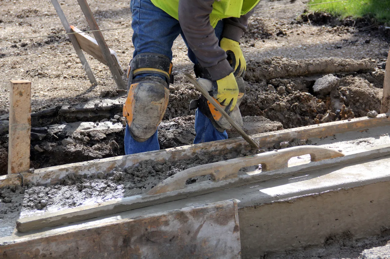 Stock photograph of concrete placement and hand finishing.